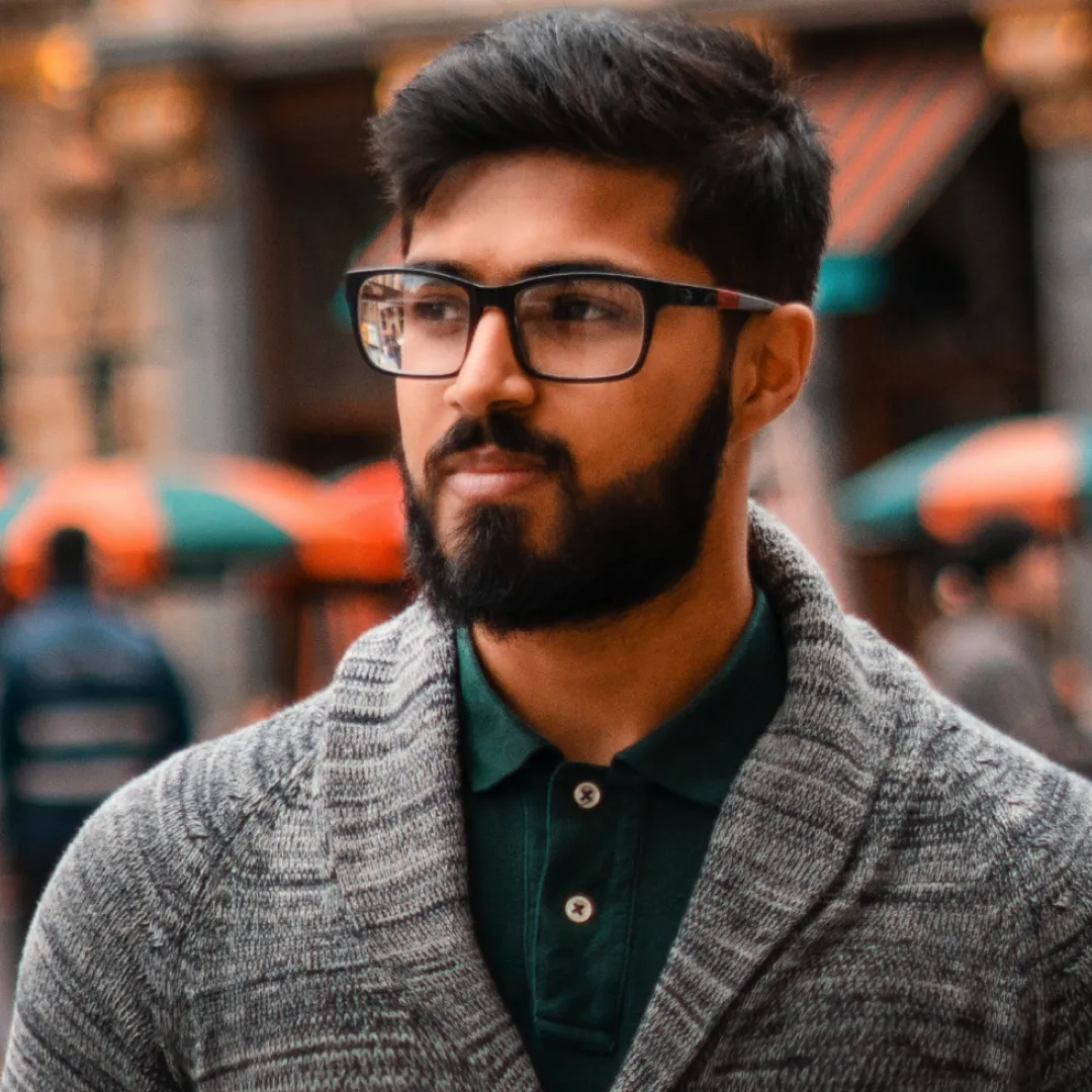 man with glasses and a beard in a city